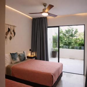 a bedroom with a bed and a ceiling fan at NEW 2 bed swim-up, gril with jacuzzi Aldea Zamá in Tulum +53 photos
