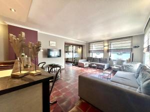 a living room with a couch and a table at Le Grand Vallon in Polleur