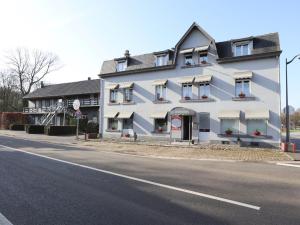 a white building on the side of a street at Le Grand Vallon in Polleur