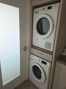 a kitchen with a microwave and a washer and dryer at Sheehan's in Bealaclugga