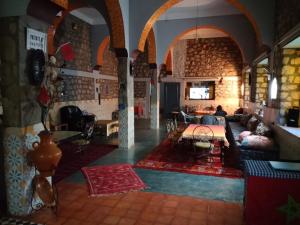 a living room with a couch and a table at Hotel AZUL Todra Gorges in Tinerhir