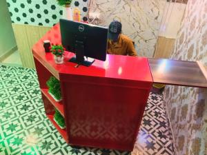 a man standing at a desk with a computer at Palace inn Hotel in Dargai +7 photos