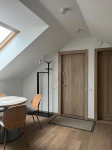 a room with a table and a wooden door at 7 Levandos in Palanga