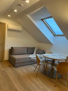 a living room with a couch and a table at 7 Levandos in Palanga +18 photos