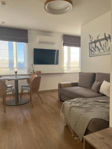a living room with a couch and a table at 7 Levandos in Palanga