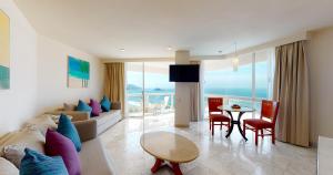 a living room with a couch and a table at Park Royal Beach Ixtapa - All Inclusive in Ixtapa