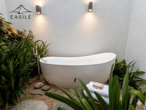 a white bath tub in a garden with plants at Villa Fontainebleau in Grand-Baie +16 photos