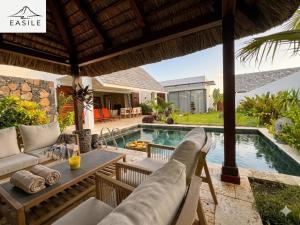 a villa with a swimming pool and a patio at Villa Fontainebleau in Grand-Baie