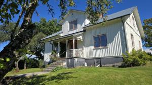 a house on a hill with a tree at The Sheep Inn B&B in Arvika