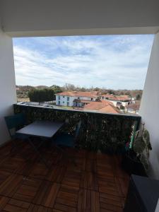 a balcony with chairs and a view of a city at Les Embruns de Tarnos in Tarnos