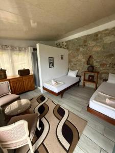 a room with two beds and a table and chairs at White Scale Agroturizmo in Bar