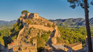 a castle on the side of a mountain at Casa Portalet in Xàtiva