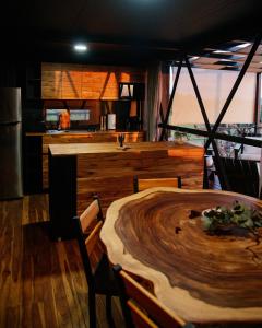 a kitchen and dining room with a wooden table at Águila Lodge in San Miguel de Allende