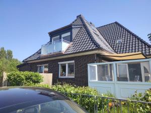 a house with a roof with a balcony on it at Pension Feuerschiff in Borkum +1 photo