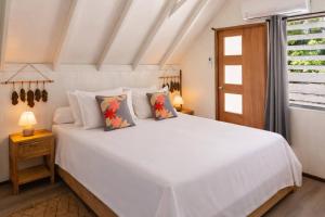 a bedroom with a white bed and a window at Matira Sunset House N659 DTO-MT in Bora Bora