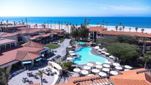 an aerial view of a resort with a swimming pool and the ocean at Zachari Dunes on Mandalay Beach, Curio Collection by Hilton in Oxnard