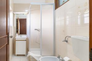 a bathroom with a shower and a toilet and a sink at Casa da Bé in Vila Nova de Milfontes +23 photos