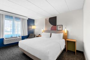 a hotel room with a bed and a window at Spark by Hilton Cedar Falls in Cedar Falls +57 photos