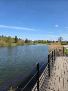 a dock on a river with water at Eden lodge Chessy - 10min Disneyland - Parking in Chessy