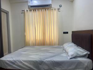 a bedroom with a bed with a television on the wall at Beach Flat in Bhīmunipatnam
