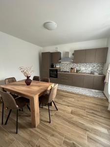 a dining room with a wooden table and chairs at Casa Cianetta in San Dorligo della Valle