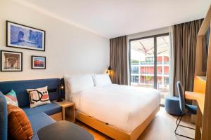 a hotel room with a bed and a couch at Hampton By Hilton Ben Guerir in Benguerir +37 photos