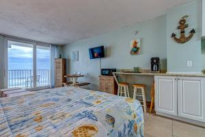 a bedroom with a bed and a view of the ocean at The Ocean Calls Harbour Beach 612 in Daytona Beach