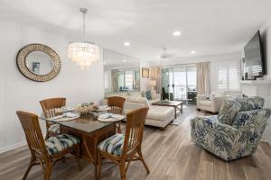 a dining room and living room with a table and chairs at 2 Bedroom Bayside Condo with Pool in OCMD in Ocean City