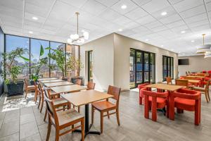 a restaurant with tables and chairs and windows at Sonesta Select Hotels Statesville in Statesville