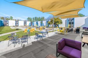 an rendering of a patio with tables and chairs at Sonesta Select Hotels Statesville in Statesville