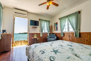 a bedroom with a bed and a view of the ocean at Faro del Colibri in Bocas Town