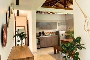 a kitchen with a table and some plants in it at Casa Dornella - Casa de Hospedaje in Guaduas