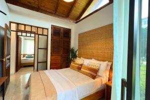 a bedroom with a large bed with a wooden headboard at Casa Dornella - Casa de Hospedaje in Guaduas +43 photos