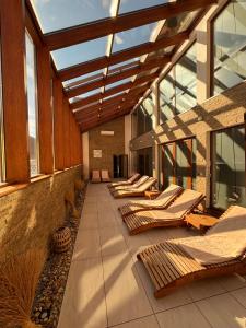 a row of lounge chairs on a building with windows at Hotel DARO in Banská Štiavnica