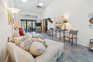 a living room with couches and a dining room at Sea Woods Home 4205 in New Smyrna Beach
