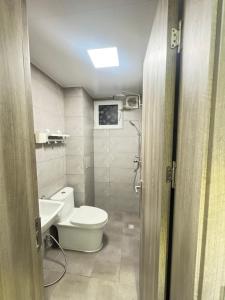 a bathroom with a toilet and a sink at Snapstay103 in Hulhumale