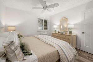 a bedroom with a bed and a ceiling fan at 2 Bedroom Bayside Condo with Pool in OCMD in Ocean City +35 photos