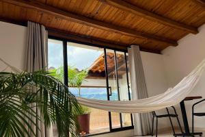 a hammock in a room with a large window at Casa Dornella - Casa de Hospedaje in Guaduas