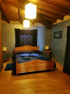 a bedroom with a wooden bed in a room at Holiday home Ca' del Cinema in Mombercelli
