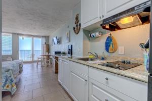 a kitchen with a sink and a counter top at The Ocean Calls Harbour Beach 612 in Daytona Beach