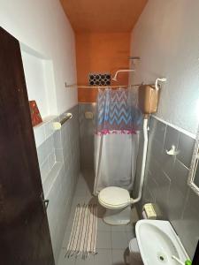 a small bathroom with a toilet and a sink at Pousada Casa do Josef in Canoa Quebrada +35 photos