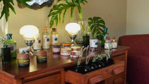a table with bottles of wine and plants on it at Siramat Hotel in Petrópolis