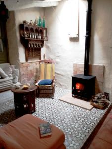a living room with a fireplace and a couch at Cortijo Aldamuz-VTAR102 in Oria +19 photos