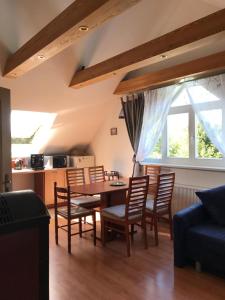 a kitchen and dining room with a table and chairs at Forest Paradise in Stružná +21 photos