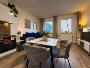 a living room with a table and chairs at The Minimalist Suite in Šurany