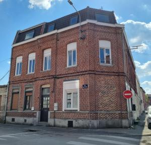 a red brick building on a street with a stop sign at L'Horizon - AbsoluteHome in Croix