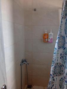 a shower with a shower head in a bathroom at Calm Rooms in Agioi Apostoli