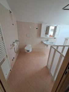 a bathroom with a toilet and a sink at Casa Nonna Adelaide in Roncone +18 photos