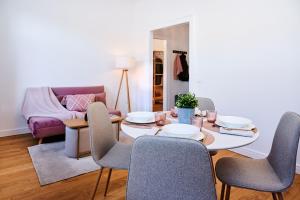 a living room with a table and chairs at TORTORELLA Apartments in Gorizia