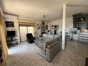 a living room with a couch and a chair at Krista's house in Agioi Theodoroi